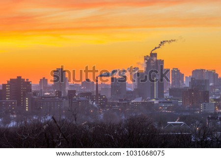A Telephoto Shot Compressing Layers of Buildings of Minneapolis During a Vibrant Winter Sunset