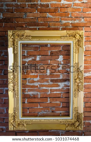 Classic gold frame isolate on red brick wall background.