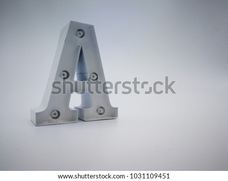 Alphabet capital letter A. Metal material coated inate white color. Isolated in white background.