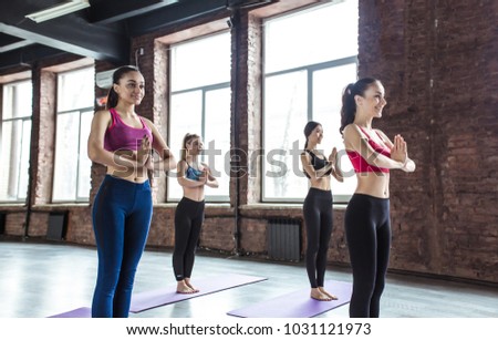 Group of young and beautiful women at the gym in a yoga class
