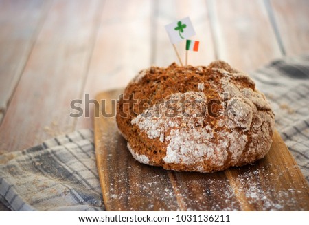 Homemade whole wheat irish soda bread decorated by irish flag and cloverleaf Royalty-Free Stock Photo #1031136211