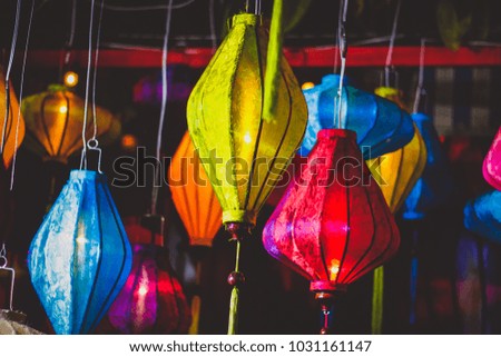 Colorful of lantern and light blub in thai street food blurred background of light in New Year Chinese celebration festival.Vintage nigh flim grain Style.