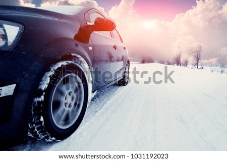 black car at winte on the snowly road
