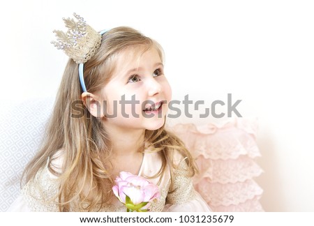 Cute Little Caucasian Girl in Pastel Pink Dress Princess Preparing for Birthday Party Concept Queen Crown on Head Springtime Royalty-Free Stock Photo #1031235679