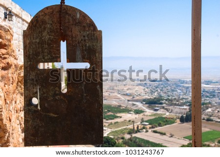 Horizontal picture of a cross on a metal plate on the top of Monastery of the Temptation, an Orthodox Christian monastery, located in Jericho, Israel