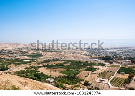 Wide angle picture of local farms irrigated by Jordan River in the desert located in the city of Jericho, Israel