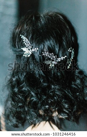 Young beautiful bride with a beautiful diadem in the hair poses standing on dark blue background.