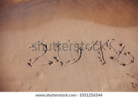 inscription on the sand, the inscription on the shore of the ocean in the summer of 2018 year