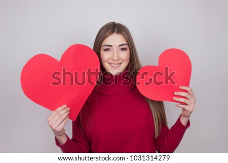 beautiful young girl holding a paper hearts