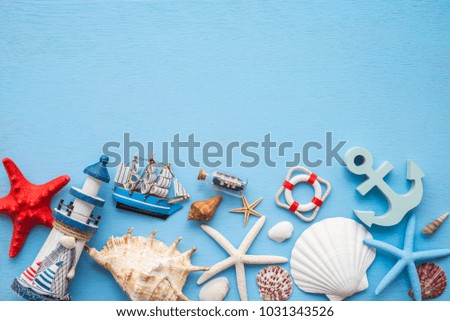 Flat lay of tropical beach summer holiday with beach summer accessories for traveling on blue wooden background