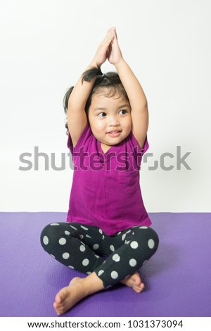 Asian little kid cute child girl practicing yoga exercise with smile and happiness, isolate on white background