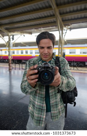 Portrait of handsome Persian tourist man at the railway station in Bangkok, Thailand
