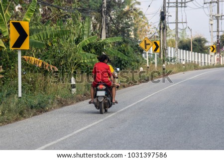 The motorcycle driver does not wear a helmet.Traffic Safety