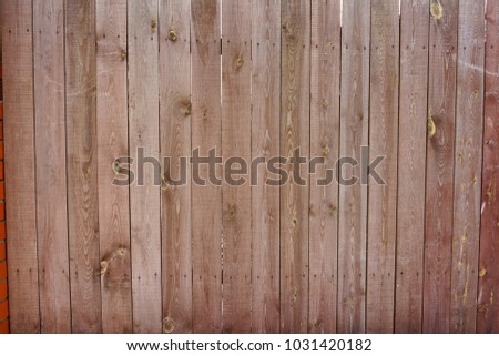 Vintage wooden fence with traces of old paint, scuffs and scratches. Photo close-up