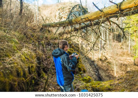 Photographer taking pictures over fall tree. Man taking pictures over fall tree branches leaves on mountain colorful forest. Young man takes pictures standing in spring time season forest 