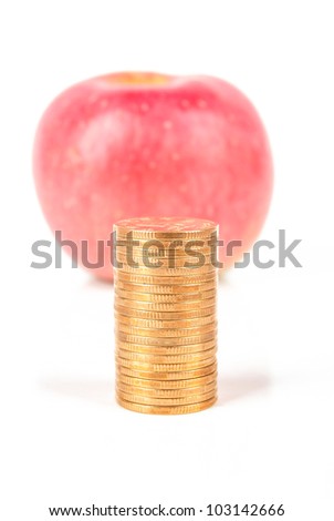 Apple with coin on white background