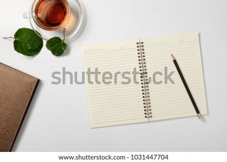 Creative flat lay of workspace desk with note book and tea cup.  with copy space background, minimal style