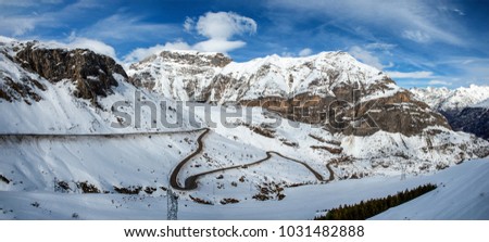 snowy Pyrenees mountains with a small winding road