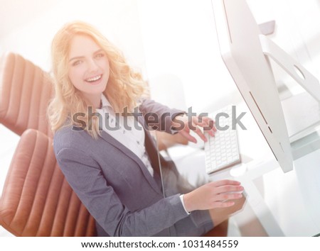smiling business woman sitting behind a Desk