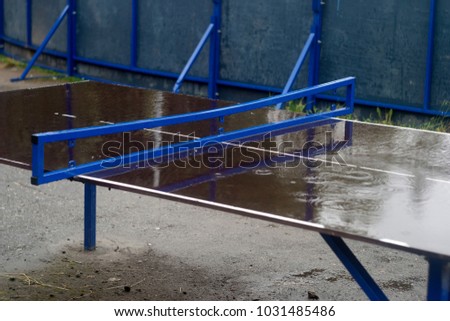 Table for tennis with raindrops. Summer sports background 