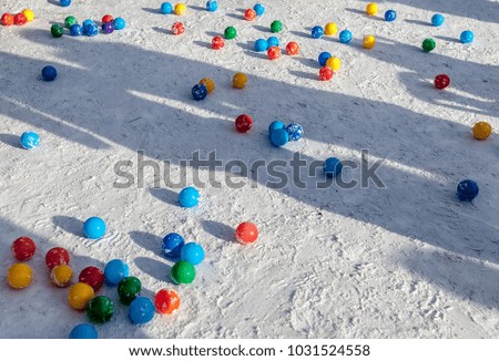 Colored plastic balls in the snow