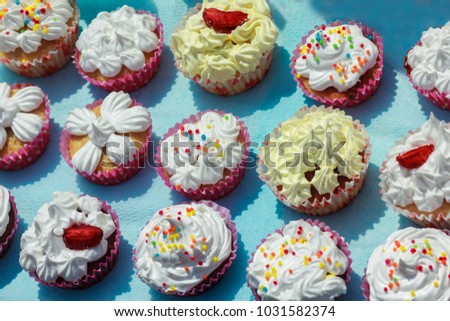 Colorful cakes on the blue background in a sunny day
