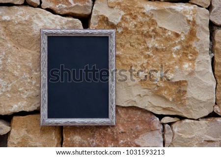 photo frame on a stone wall. mock up.
