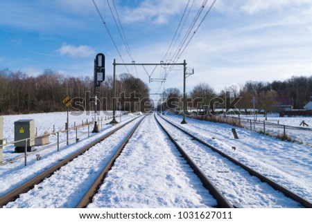 straight railroad in winter time covered with snow
