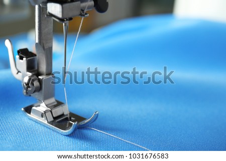Sewing machine with fabric and thread, closeup Royalty-Free Stock Photo #1031676583