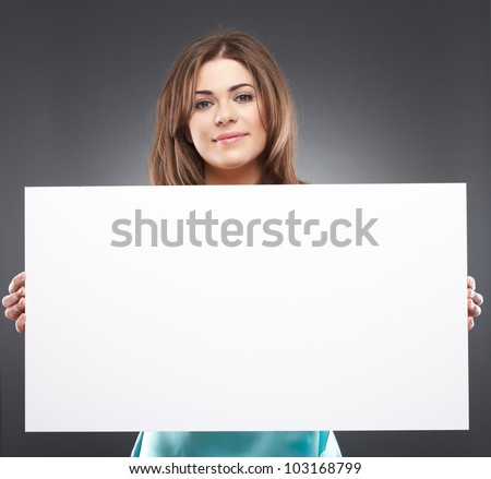 Portrait of young woman with blank white board on gray isolated