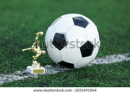 Prizes for the best football players with classic black and white soccer ball