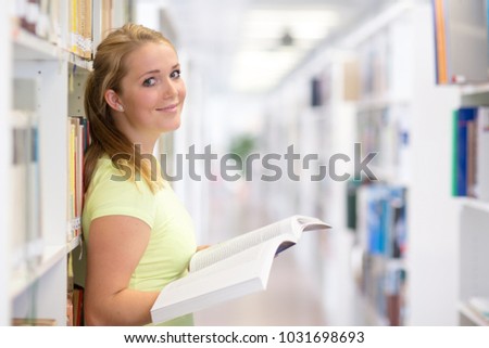 Pretty, female student in a library