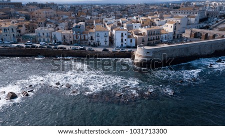 Aerial view by drone of the ancient Island of Ortigia, Syracuse, Italy, Sicily - Mediterranean Sea. Small Italian Town under UNESCO World Heritage