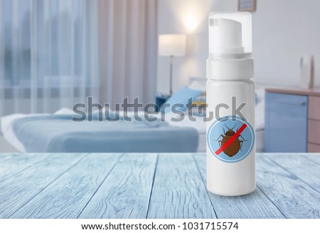 Bottle of anti bed bug detergent on table in bedroom