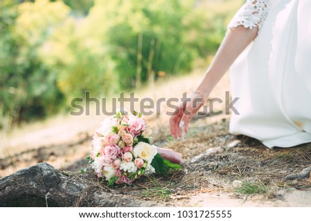 bride in nature with a beautiful wedding bouquet