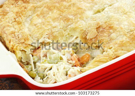 Above view of fresh Chicken Pot Pie with wooden spoon.  Shallow depth of field.