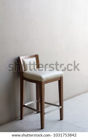 Vintage Wooden Chair in front of the gradient grey wall.