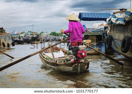 Woman selling watermelon is going to the Floating market in a boat at the delta Mekong in Can Tho, Vietnam