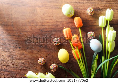 Fancy Easter eggs and tulips flower decoration on wooden backgrounds with copy space for your text