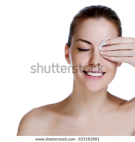 Young beautiful girl cleans the eye make-up Royalty-Free Stock Photo #103182881