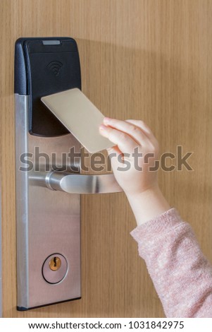 Ease of use. Children's hand touch keycard on hotel door