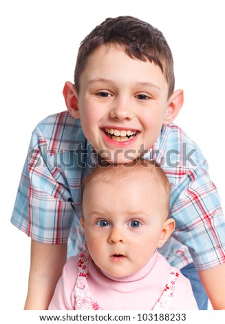 Close-up portrait of happy children in studio. Brather and sister looking at camera, isolated on white background.