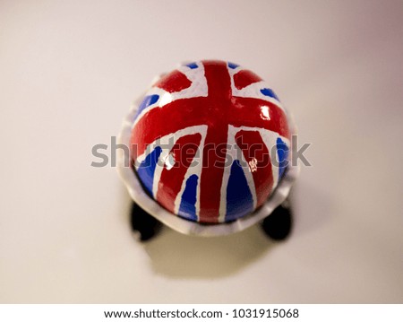 A British flag egg in a novelty egg cup, with legs.