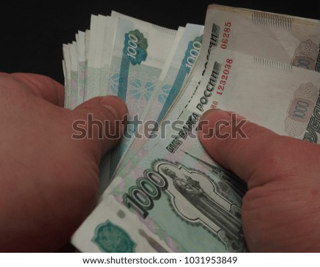 The man counts the money. Russian rouble. Human hands are visible. Close up.