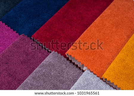 Colorful and bright fabric pattern palette texture samples as abstract textile background. Handmade, clothes and furniture decoration concept. Closeup studio shot with soft selective focus. Toned.
