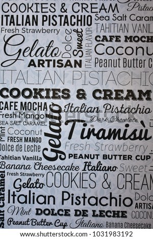 a white board in an ice cream shop wall, showing menu with name of all best ice creams name written on it in different fonts.