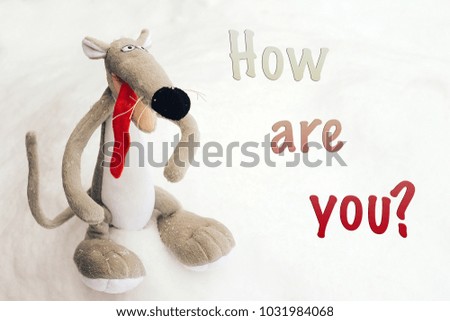 Cheerful little mouse with a protruding red tongue on a white background and the inscription " how are you?".