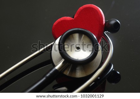 Image of heart and stethoscope on black background. Health and Medical concept.