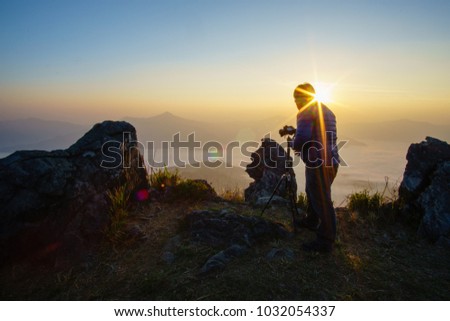 Men who are taking nature pictures Sunset time, silhouette