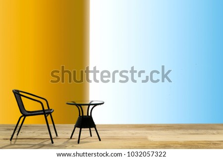 black chair and black circle table on wooden floor  front of colorful background 